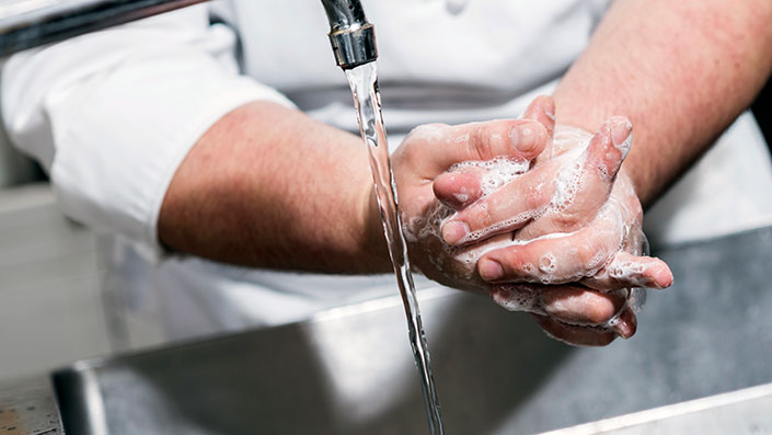 hands washing with soap under tap