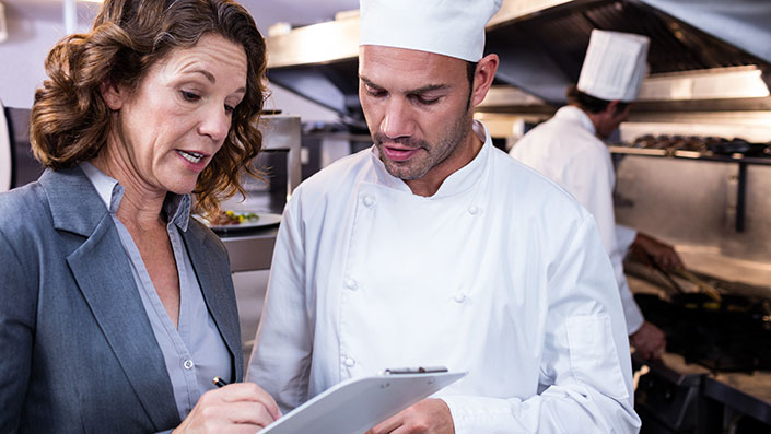 Health Inspector conducting inspection at a restaurant