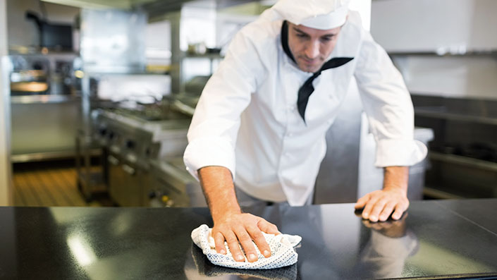 chef wiping down a surface