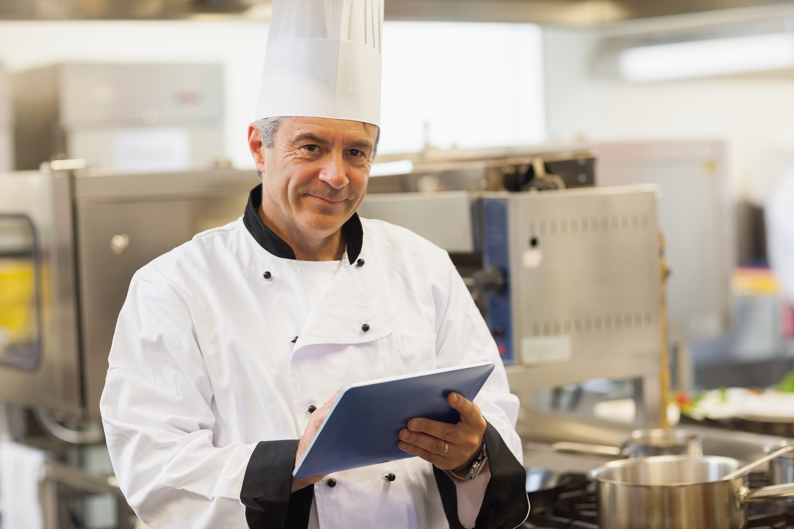 chef getting food safety certificate online using a tablet